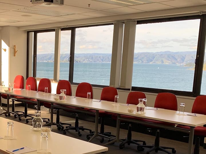 Conference room with u-shaped table layout and harbour views