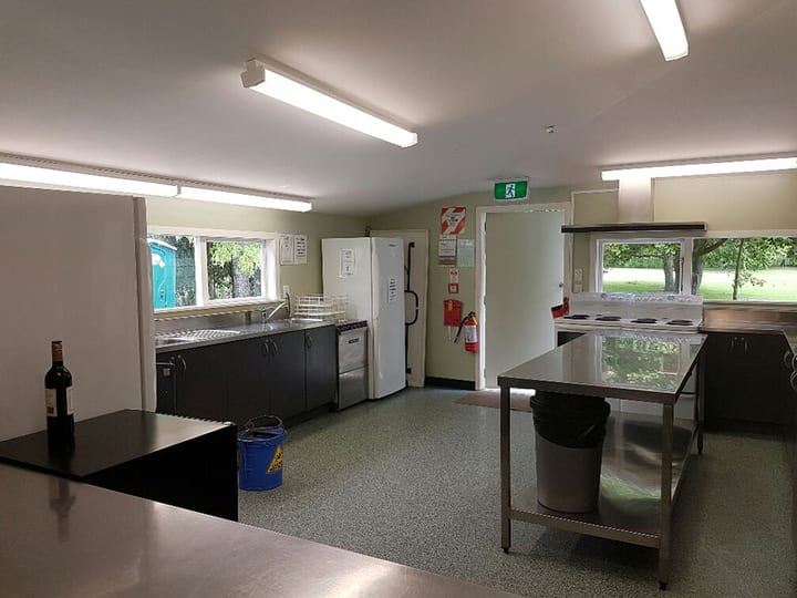 Kitchen servery hatch looking through to a commercial kitchen