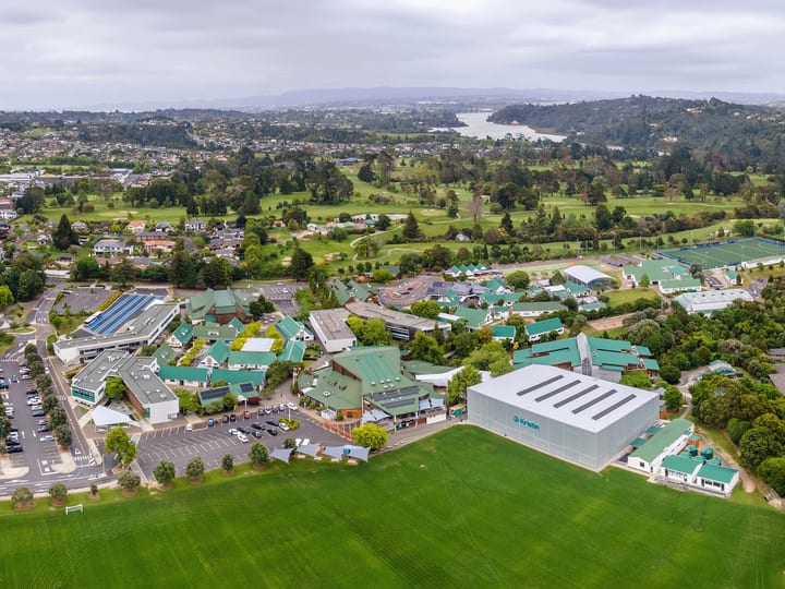 Aerial view of large school campus with sports fields and buildings