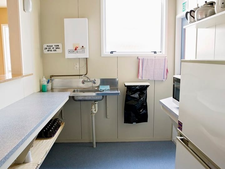 Narrow kitchenette with sink, counter and small appliances