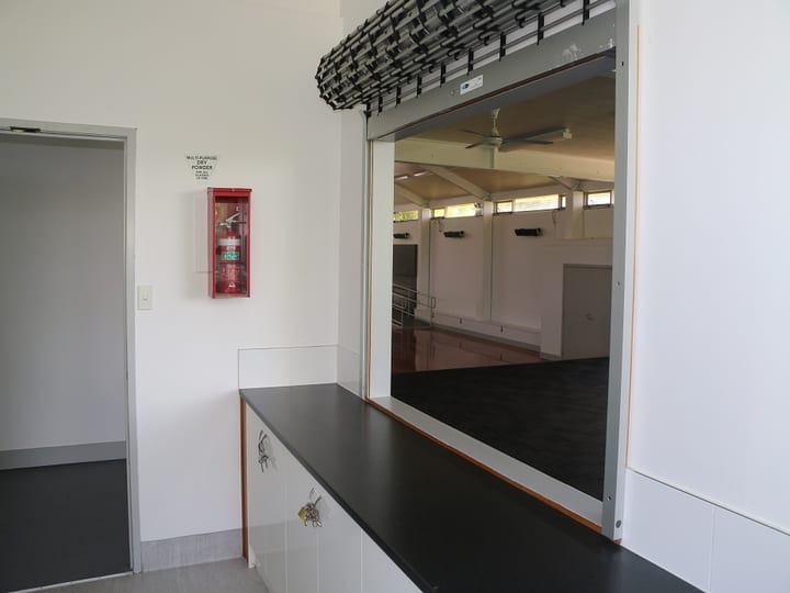 Bar servery counter with pass-through hatch opening to a hall interior
