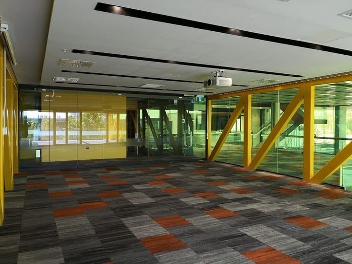 Flexible event space with yellow structural frames and multicoloured carpet