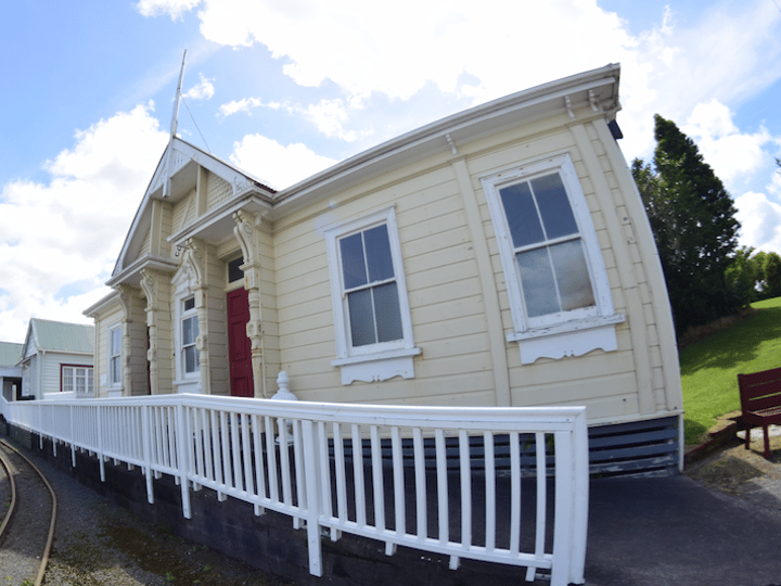 Heritage timber courthouse building with ornate facade and white railed verandah