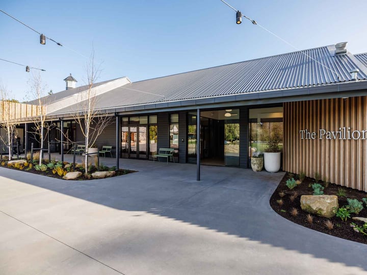 The Pavilion building entrance with corrugated roof and timber slat cladding