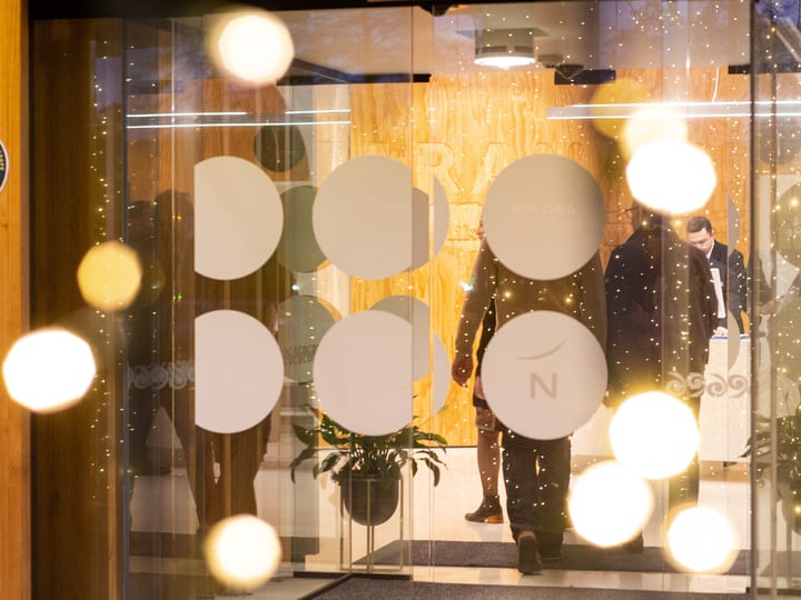 Hotel entrance lobby viewed through glass doors with decorative dot pattern