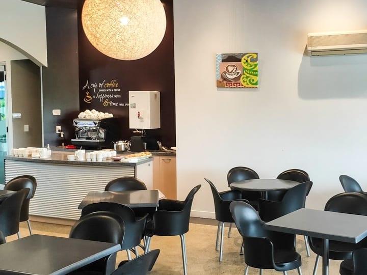 Cafe area with pendant lights, counter and round tables