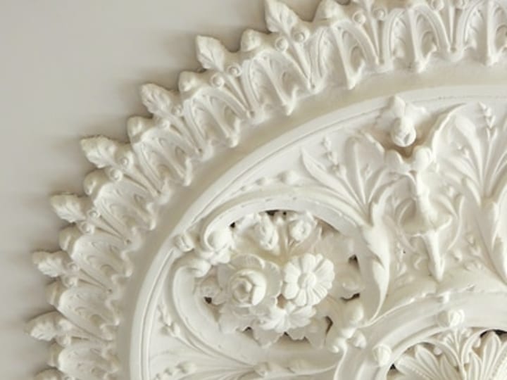 Ornate white plaster ceiling rose with detailed floral and acanthus relief
