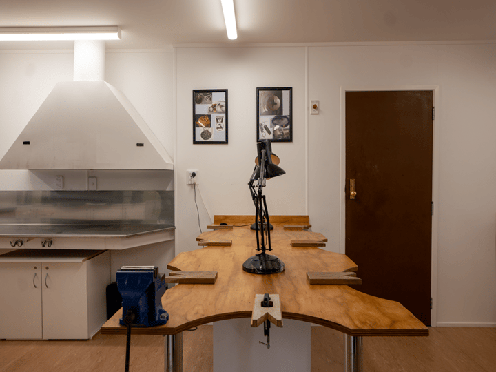 Jewellery workshop with live-edge timber benches, task lamps and sink area