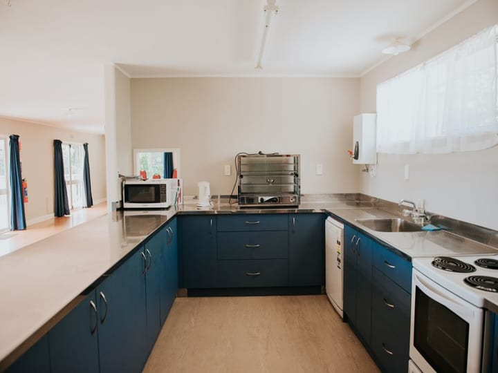 Hall kitchen with blue cabinetry, stainless benchtops and appliances
