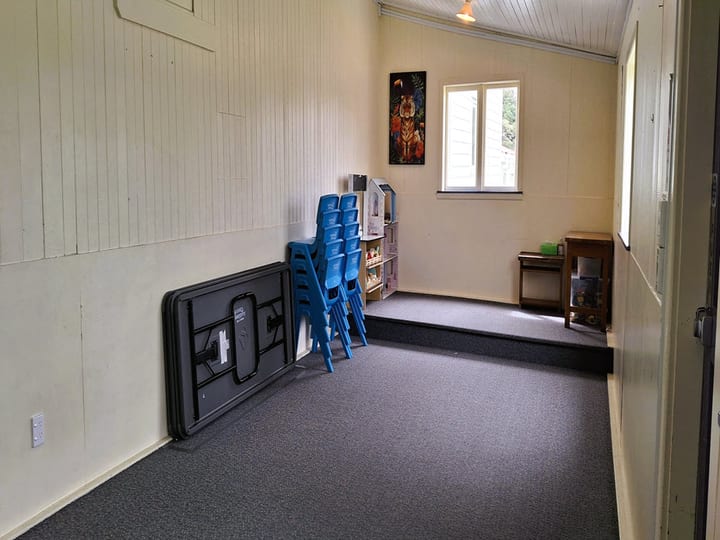 Narrow corridor interior with blue storage cupboards and air conditioning unit