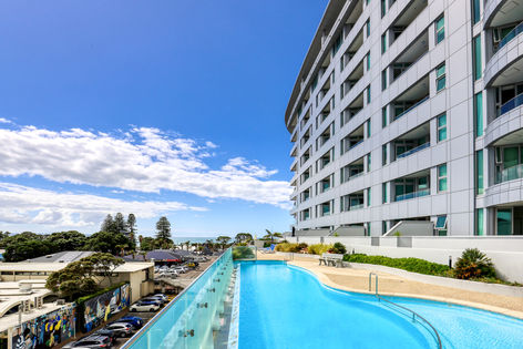 Multi-storey hotel building with pool terrace and sea view