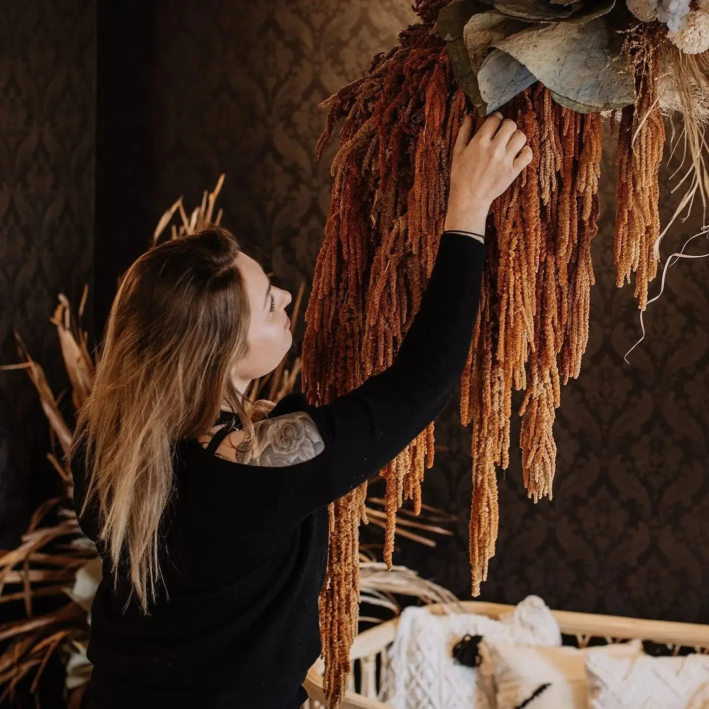 Florist working with dried foliage