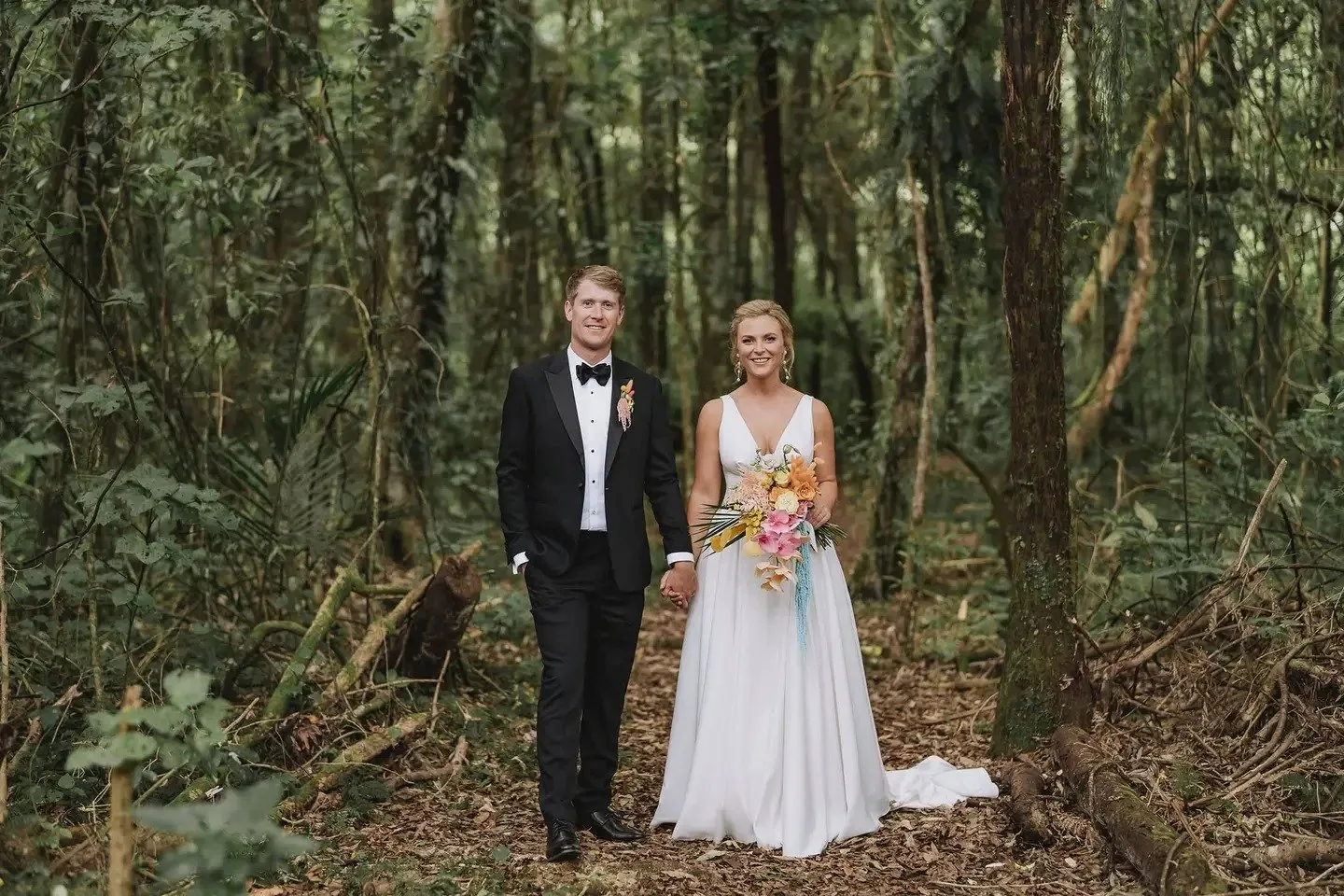 Couple in forest with mixed bouquet