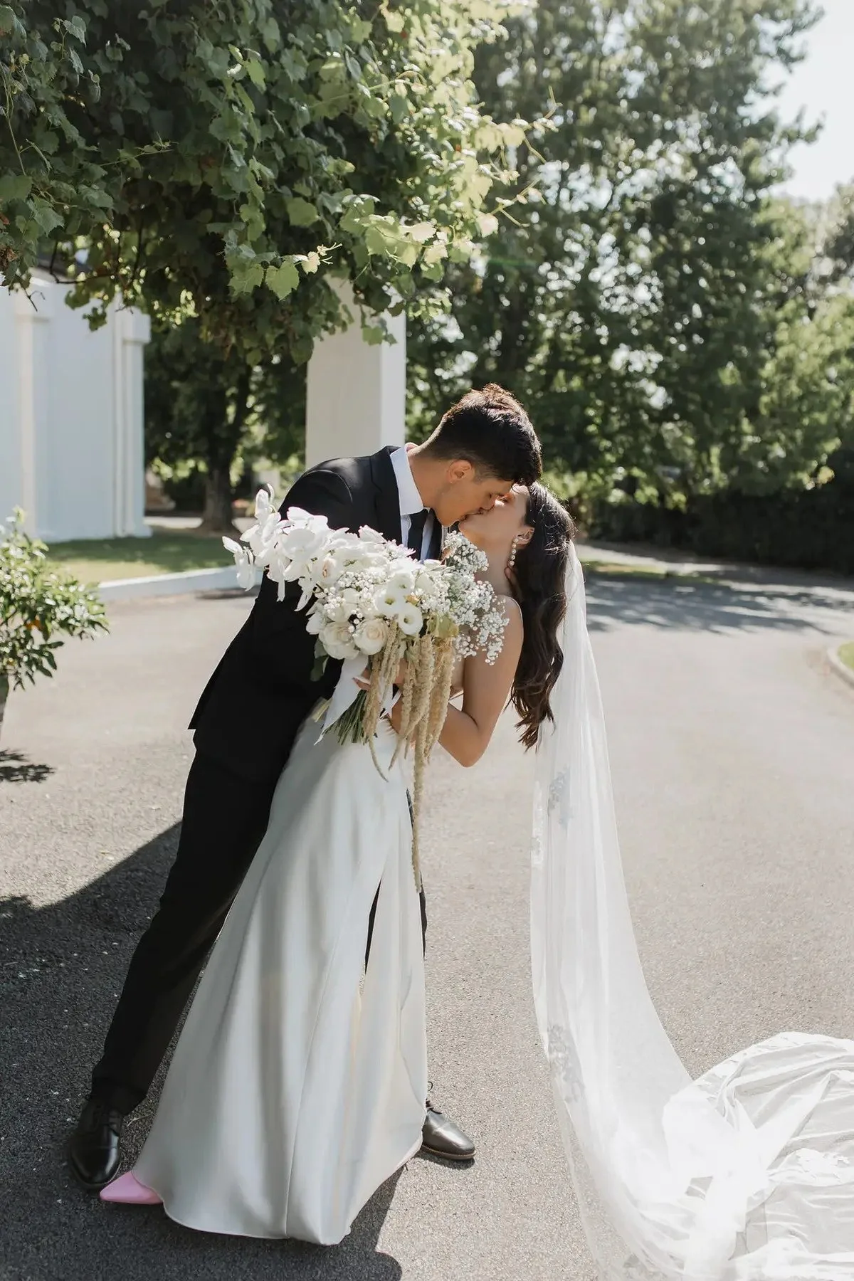 Bride and groom with white bouquet