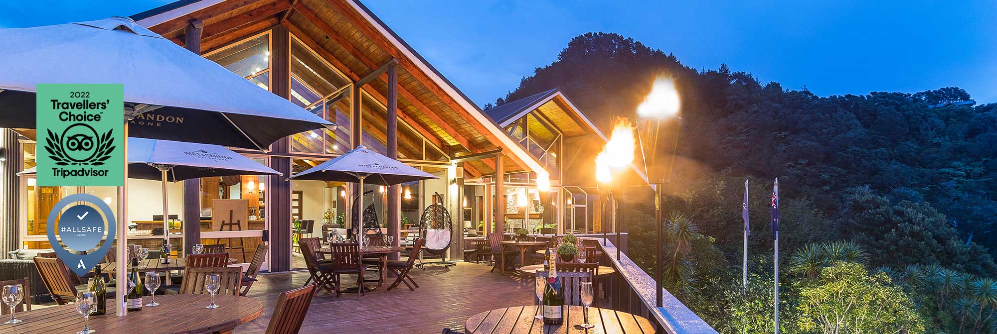 Outdoor resort deck with dining tables and flaming torches at night