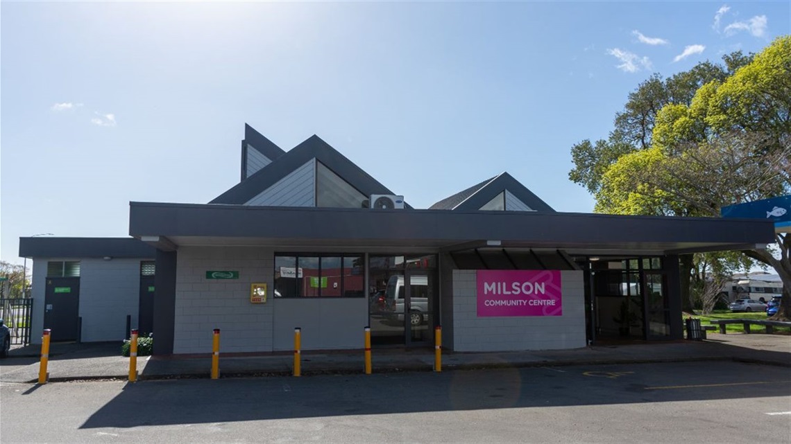 Front of Milson Community Centre with pink sign, covered entrance and car park