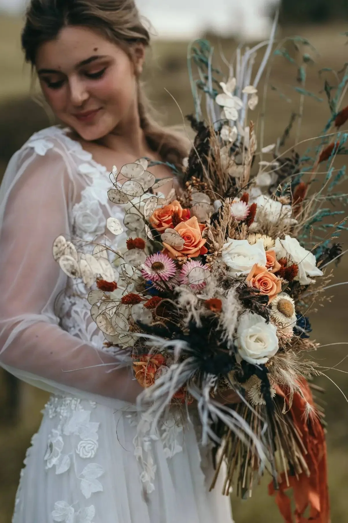 Bride holding coral and pink bouquet