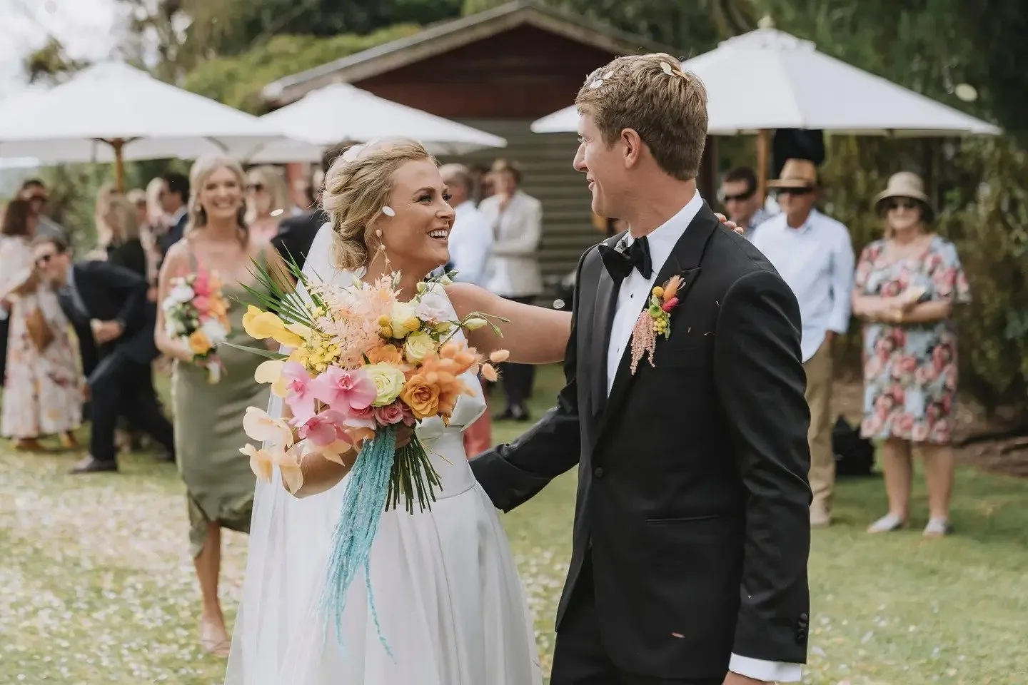 Bride at outdoor ceremony with tropical bouquet
