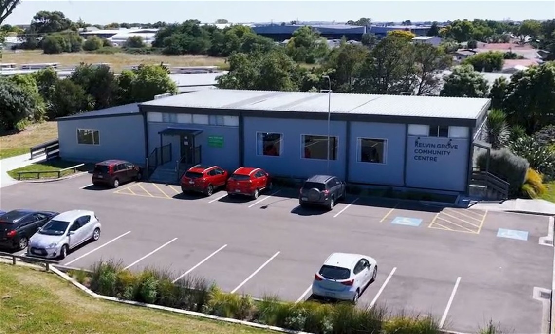 Single-storey Kelvin Grove Community Centre with a car park and trees behind